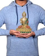 Brass Buddha statue (9.5 in) held in hands, seated figure with green-and-red robe