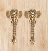 Ganesha face brass door handle pair with striped shank and etched patterns.