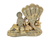Brass Sheshnag hood behind Lakshmi and Vishnu idol statue, detailed serpent base
