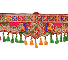 Close-up of peacock toran border: red band, gold trim, green and blue peacock details