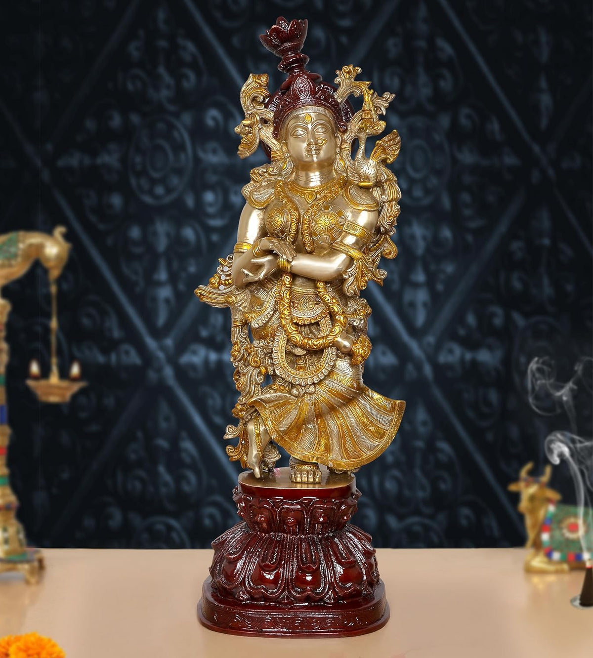 Brass Radha Rani idol with gold and dark red accents, standing on ornate base