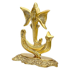 Gold metal Ganesha idol with butterfly-shaped ears, ornate pedestal base