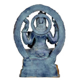 Back view of Shiva sculpture with dark blue torso, circular halo, and gold accents