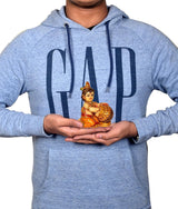 Resin Laddu Gopal idol in hands, 4 inch seated figure with butter pot and crown.