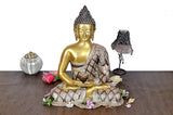 Brass Buddha meditation statue with gold face and patterned robe, seated lotus pose