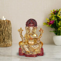 Brass Ganesha idol statue, seated four-armed, red crown and base