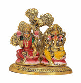 Lakshmi and Ganesha metal idol, detailed faces and red-yellow garments on base