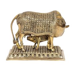 Brass cow showpiece with calf, front view, floral relief design on back panel