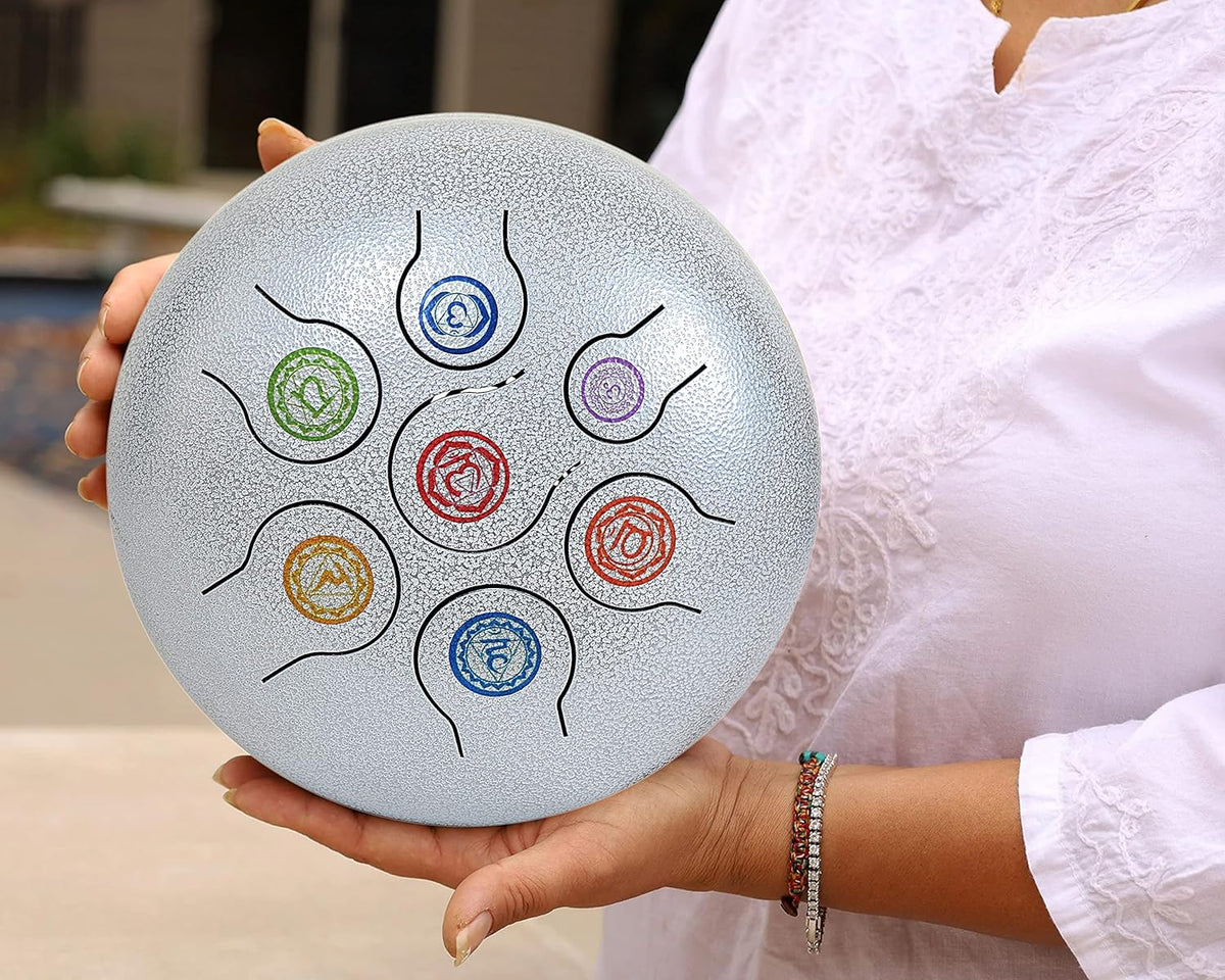 Silver steel happy drum with colorful spiral note pattern, held in hands