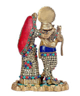 Brass Radha Krishna idol from side, Radha's red veil and ornate jewelry.