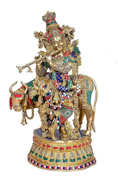 Brass Krishna statue with jeweled crown and cow companions, ornate sitting base