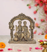 Brass Vishnu and Lakshmi statue with ornate arch and seated figures