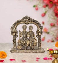 Brass Vishnu and Lakshmi statue with ornate arch and seated figures