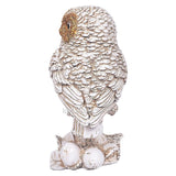 Side view polyresin owl figurine with textured feather body and curled feet