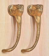 Brass Ganesha face door handle pair, gold-tone detailing on head and curved base