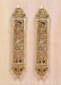 Pair of golden brass door pull handles with vertical filigree flower motifs