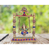 Gold brass Ganesha swing idol with painted blue, red, and green details