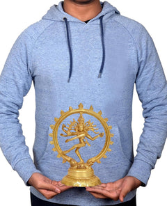Brass Nataraj statue held in hands; circular halo design on pedestal base