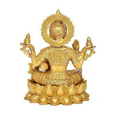 Rear view golden brass Lakshmi statue with halo details and four raised hands