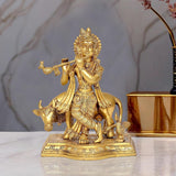 Brass Krishna figurine with cow figures, playing flute, ornate base, 9-inch statue