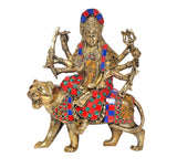 Durga Maa idol on lion with raised hands and ornate multicolor clothing