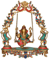 Ganesha swing centerpiece on ornate platform with twin kneeling attendants