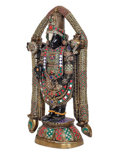 Multicolored idol statue from side view, gold-toned arched arms and jeweled dress