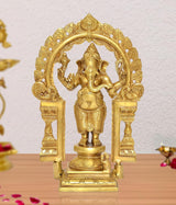 Brass standing Ganapati statue with ornate prabhavali arch, hands raised