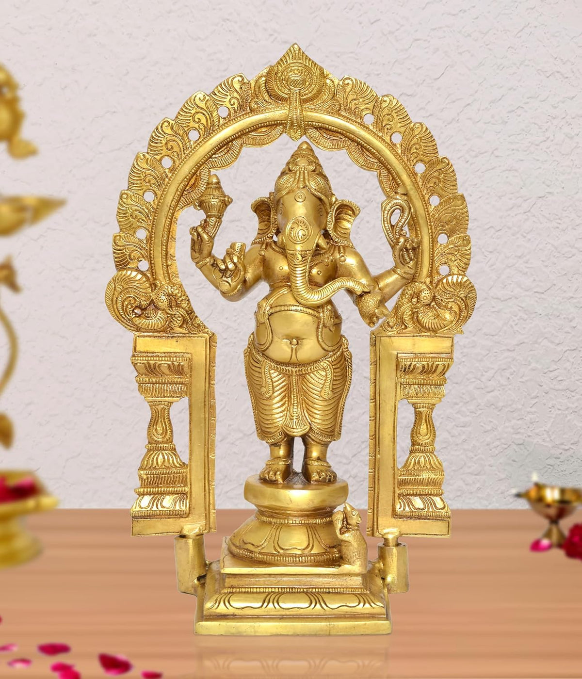 Brass standing Ganapati statue with ornate prabhavali arch, hands raised