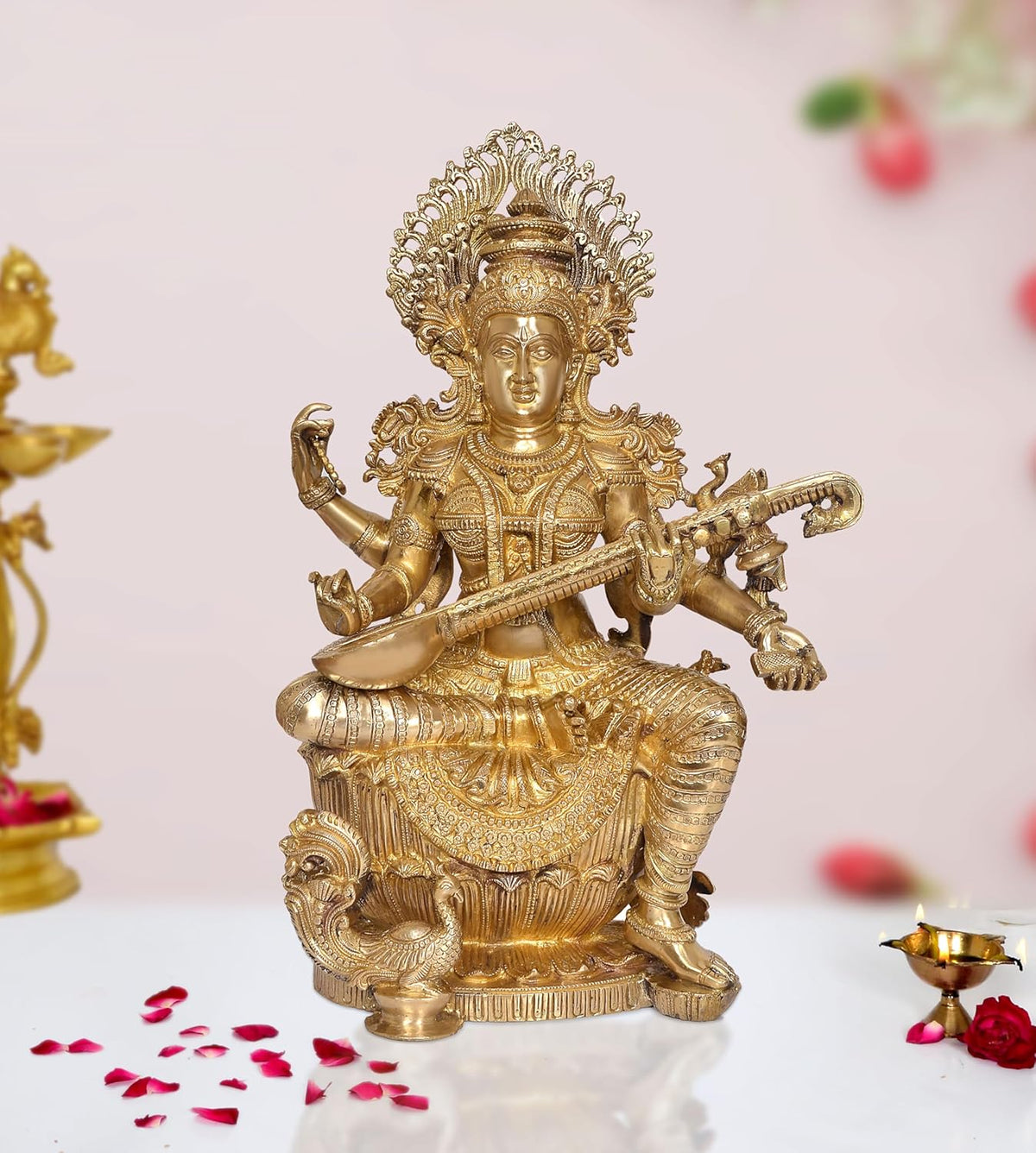 Brass Maa Saraswati statue seated, playing veena, ornate crown and jewelry