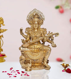 Brass Maa Saraswati statue seated, playing veena, ornate crown and jewelry