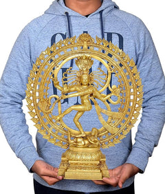 Brass Nataraj Lord Shiva idol held in hands, ornate halo and pedestal base
