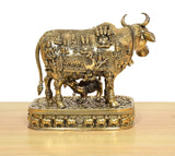 Rear-left view of Kamdhenu cow murti with calf god figure on ornate base