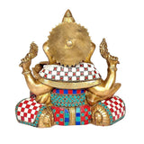 Back view brass Ganesha idol with colorful red, blue, and white patterned inlays