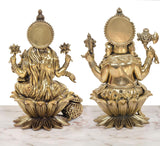 Back view: brass-finish Lakshmi and Ganesh statues on lotus bases with embossed details