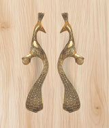 Peacock motif brass door handles with curved bodies and round thumb grips