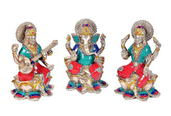 Lakshmi Ganesha Saraswati trio statue, silver finish, front view with crowns and raised hands