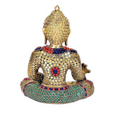 Seated brass Buddha idol with detailed stone work on back and crown, colorful blue-red-green