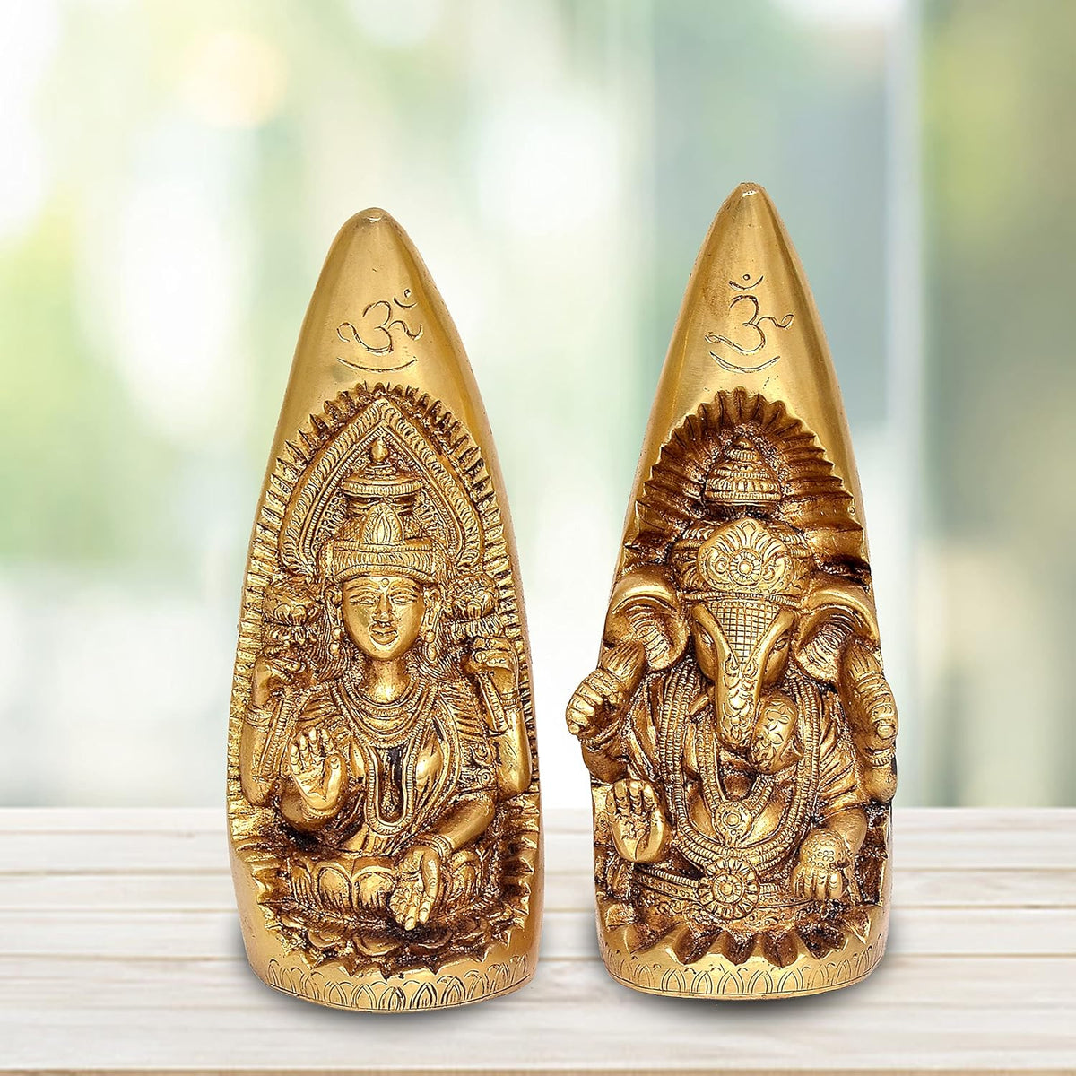 Brass Ganesh and Lakshmi idol showpiece on tusk shape, front view of two cones