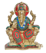Sitting Ganesha statue with gold finish, red headgear, teal-green and red jeweled patterns