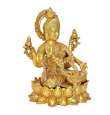 Golden brass Lakshmi idol front view, holding small emblems and seated on lotus