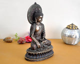Resin Lord Buddha statue, seated posture with raised hand and decorative halo