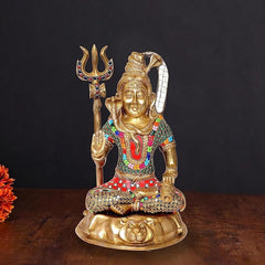 Brass Lord Shiva seated idol with trident, colorful ornaments, 13 in height.