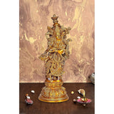 Gold-tone brass Radha Rani idol sculpture, ornate crowned figure standing on pedestal.