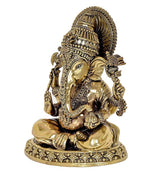 Brass Ganesha idol side view with patterned jewelry, halo headpiece, seated on base