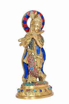 Brass Krishna playing flute figurine, close view of gold face and striped halo