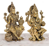 Rear/side view of brass-finish Lakshmi and Ganesh statues with decorative ornaments