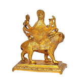 Durga brass statue on lion, side view of multi-armed goddess on engraved platform base