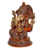 Brass Ganesha statue side angle, seated pose with decorative headpiece and jewelry
