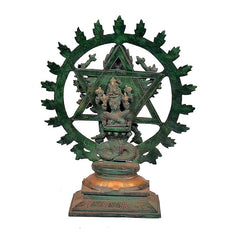 Ornate metal idol with halo disc and seated figure, detailed base platform view
